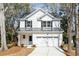 Charming two-story home showcasing black shutters and a spacious two-car garage at 1630 Balsam St, Charleston, SC 29407