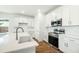 Modern kitchen featuring stainless steel appliances, white cabinetry, and a farmhouse sink at 1630 Balsam St, Charleston, SC 29407
