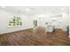 Bright, open-concept living space with wood floors connects to the kitchen and outdoor patio at 1630 Balsam St, Charleston, SC 29407