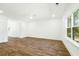 Inviting living room with wood floors, large window, and neutral tones for a serene feel at 1630 Balsam St, Charleston, SC 29407