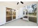 A screened porch with a ceiling fan and sliding glass door leads to the backyard at 1630 Balsam St, Charleston, SC 29407