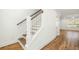 Staircase with wood steps, white banister and wood flooring at 1630 Balsam St, Charleston, SC 29407
