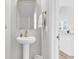 Elegant powder room with pedestal sink, gold fixtures, and a modern mirror, offering a touch of luxury at 171 Cantona Dr, Summerville, SC 29483