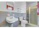 Small bathroom with gray tile, white toilet, and shower stall at 1929 Westminster Rd, Charleston, SC 29407