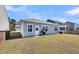 Cozy backyard features a grassy lawn, a gas grill, and an attached back porch at 1941 Zonny Moss Dr, Johns Island, SC 29455