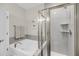 Bright bathroom features a glass-enclosed shower, a bathtub, and neutral decor at 1941 Zonny Moss Dr, Johns Island, SC 29455
