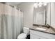 Cozy bathroom featuring granite countertop vanity and patterned shower curtain at 1941 Zonny Moss Dr, Johns Island, SC 29455