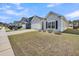Charming gray one story home showcasing a well-manicured front yard and attached garage at 1941 Zonny Moss Dr, Johns Island, SC 29455