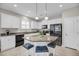 Bright kitchen featuring white cabinetry, granite countertops, and a stylish center island at 1941 Zonny Moss Dr, Johns Island, SC 29455