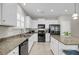 Modern kitchen features white cabinets, granite countertops, and stainless steel appliances at 1941 Zonny Moss Dr, Johns Island, SC 29455