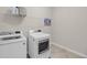The laundry room boasts a modern washer and dryer set with shelving for storage at 1941 Zonny Moss Dr, Johns Island, SC 29455