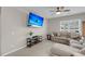 View of comfortable living room with sofa and flatscreen, bathed in natural light at 1941 Zonny Moss Dr, Johns Island, SC 29455