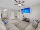 Open living room with ceiling fan, plush sofa and mounted flatscreen television at 1941 Zonny Moss Dr, Johns Island, SC 29455