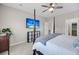 Bright main bedroom features a four poster bed, television, and neutral decor at 1941 Zonny Moss Dr, Johns Island, SC 29455