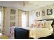 Comfortable bedroom features flamingo themed bedding, flamingo throw pillows, and a ceiling fan at 203 Candleberry Cir, Goose Creek, SC 29445
