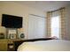 Bedroom with floral print drapes, TV, and unique glass lamps on bedside tables at 203 Candleberry Cir, Goose Creek, SC 29445