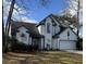 Charming two-story home featuring white siding, a dark roof, attached garage and well-manicured landscaping at 203 Candleberry Cir, Goose Creek, SC 29445