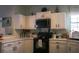Bright kitchen features white cabinets and countertops and sleek black appliances at 203 Candleberry Cir, Goose Creek, SC 29445
