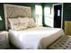 Sun-filled main bedroom with white bedding, lamps, and a view of the closet at 203 Candleberry Cir, Goose Creek, SC 29445