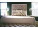 Stylish main bedroom features white bedding, decorative headboard, and natural light at 203 Candleberry Cir, Goose Creek, SC 29445