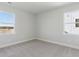 Bright bedroom featuring plush carpeting and two windows offering scenic neighborhood and water views at 217 Denham St, Summerville, SC 29486