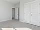 Neutral bedroom featuring plush carpeting, an open doorway, and a large double-door closet at 217 Denham St, Summerville, SC 29486