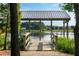 Picturesque lake view featuring a covered dock with a metal roof overlooking the water and trees at 217 Denham St, Summerville, SC 29486