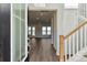 Bright foyer with wood floors, white staircase, and view into the living area with water views at 217 Denham St, Summerville, SC 29486