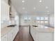 Open kitchen with white cabinets, stainless appliances, center island, and adjacent living area with water views at 217 Denham St, Summerville, SC 29486
