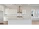 Bright kitchen featuring white cabinets, stainless steel appliances, large island, and backsplash at 217 Denham St, Summerville, SC 29486