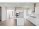 Spacious kitchen featuring white cabinets, stainless steel appliances, large island, and open layout at 217 Denham St, Summerville, SC 29486