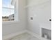 Bright laundry room featuring marble tile flooring, a window, and utility connections at 217 Denham St, Summerville, SC 29486
