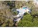 Aerial view of a home with a backyard deck and in-ground pool surrounded by lush greenery at 29 27Th Ave, Isle of Palms, SC 29451