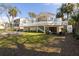 Expansive backyard featuring a covered deck, fire pit area, and lush lawn, perfect for outdoor activities at 29 27Th Ave, Isle of Palms, SC 29451