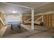 Large open basement with ping pong table, couch and exposed wood framing, perfect for recreation at 29 27Th Ave, Isle of Palms, SC 29451
