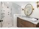 Stylish bathroom with marble countertops, wood vanity, and walk-in glass shower featuring elegant tile work at 29 27Th Ave, Isle of Palms, SC 29451