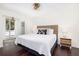 Bright bedroom features a white bedspread, wicker headboard, and ensuite at 29 27Th Ave, Isle of Palms, SC 29451