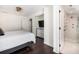 Bright bedroom features wood floors, modern lighting, and an en suite bathroom with glass shower at 29 27Th Ave, Isle of Palms, SC 29451