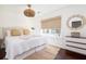 Well-lit bedroom with a queen bed, a large window, and light neutral tones at 29 27Th Ave, Isle of Palms, SC 29451
