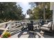 Inviting deck area with outdoor seating and a view of the surrounding trees at 29 27Th Ave, Isle of Palms, SC 29451