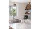 Bright kitchen features a stainless steel farmhouse sink, subway tile backsplash and open shelving at 29 27Th Ave, Isle of Palms, SC 29451
