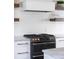 Contemporary kitchen showcases marble countertops, open shelving, and stainless steel gas range with double oven at 29 27Th Ave, Isle of Palms, SC 29451