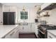 Bright kitchen features subway tile, stone counters, a farmhouse sink, open shelves and stainless steel appliances at 29 27Th Ave, Isle of Palms, SC 29451