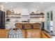 View of the kitchen with white subway tiles, open shelving, and a wine fridge at 29 27Th Ave, Isle of Palms, SC 29451