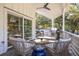 Inviting outdoor patio with wicker furniture, ceiling fan, and a grill, perfect for relaxation and entertaining at 29 27Th Ave, Isle of Palms, SC 29451