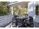Covered patio featuring a dining table with chairs and a grill, ideal for outdoor meals and gatherings at 29 27Th Ave, Isle of Palms, SC 29451