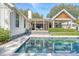 Gorgeous backyard with a modern pool, spa, an outdoor pavilion, and multiple seating areas at 299 Bampfield Dr, Mount Pleasant, SC 29464