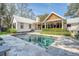 Expansive backyard featuring a modern pool, covered patio, and lush landscaping for outdoor enjoyment at 299 Bampfield Dr, Mount Pleasant, SC 29464