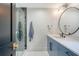 Stylish bathroom with blue vanity, round mirror, and uniquely tiled glass shower at 299 Bampfield Dr, Mount Pleasant, SC 29464