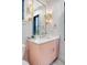 Stylish bathroom features a floating pink vanity, elegant gold light fixtures, and a large, framed mirror at 299 Bampfield Dr, Mount Pleasant, SC 29464